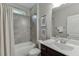 Bathroom featuring tiled walls, a shower/tub combo, modern vanity, and framed artwork at 7070 Concord Mountain Trl, Cumming, GA 30028