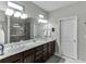 Bathroom featuring double sinks, quartz counters, and a large glass shower at 7070 Concord Mountain Trl, Cumming, GA 30028