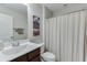 Cozy bathroom with a single sink vanity and a shower with a curtain at 7070 Concord Mountain Trl, Cumming, GA 30028