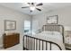 Cozy bedroom with neutral decor, featuring a metal bed frame, soft lighting, and stylish furnishings at 7070 Concord Mountain Trl, Cumming, GA 30028