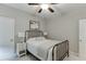 Comfortable bedroom with neutral tones, featuring a metal bed frame, soft lighting and closet access at 7070 Concord Mountain Trl, Cumming, GA 30028