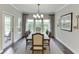 Dining room features a modern chandelier, a neutral palette, and access to the patio at 7070 Concord Mountain Trl, Cumming, GA 30028