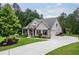 Charming home showcasing manicured landscaping, a brick facade, and an inviting driveway at 7070 Concord Mountain Trl, Cumming, GA 30028