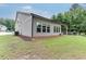 Well-maintained home exterior with a covered patio area and lush green lawn at 7070 Concord Mountain Trl, Cumming, GA 30028