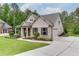 Well-maintained home showcasing manicured landscaping, an extended driveway, and attached garage at 7070 Concord Mountain Trl, Cumming, GA 30028