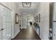 Bright hallway with hardwood floors and decorative lighting, leading to open-concept living spaces at 7070 Concord Mountain Trl, Cumming, GA 30028