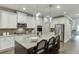 Kitchen featuring central island with bar stools and undermount sink, and stainless appliances at 7070 Concord Mountain Trl, Cumming, GA 30028