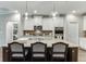 Kitchen island with pendant lighting, stone countertops and bar stools at 7070 Concord Mountain Trl, Cumming, GA 30028