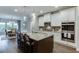 Kitchen area with central island and bar stool seating, and view to dining area at 7070 Concord Mountain Trl, Cumming, GA 30028
