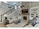 Open living room with fireplace, built-in shelving, and adjacent staircase leading to loft at 7070 Concord Mountain Trl, Cumming, GA 30028