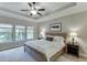 Spacious main bedroom features a tray ceiling and several windows, offering lots of natural light at 7070 Concord Mountain Trl, Cumming, GA 30028