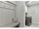 Mud room boasting stylish bench with coat hooks, and view of laundry area with washer and dryer at 7070 Concord Mountain Trl, Cumming, GA 30028
