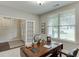 Bright home office with a wooden desk, white walls, and a large window offering ample natural light at 7070 Concord Mountain Trl, Cumming, GA 30028