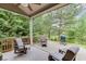 Inviting covered patio provides ample seating and views of a wooded area, perfect for outdoor living at 7070 Concord Mountain Trl, Cumming, GA 30028