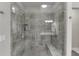 A tiled, walk-in shower with a bench and glass door at 7070 Concord Mountain Trl, Cumming, GA 30028
