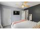 Relaxing bedroom with a calming color scheme, television, ceiling fan, and ample natural light at 735 Waterbrook Ter, Roswell, GA 30076