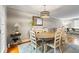 Elegant dining room with hardwood floors, stylish lighting, and comfortable seating for a perfect gathering space at 735 Waterbrook Ter, Roswell, GA 30076