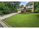Charming home with well-manicured front lawn and curb appeal. The house is set back on a sloped lot at 735 Waterbrook Ter, Roswell, GA 30076
