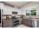 Modern kitchen featuring stainless steel appliances, granite countertops, and ample cabinet space at 735 Waterbrook Ter, Roswell, GA 30076