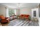 Cozy living room with a large window, comfortable furniture and modern style flooring at 735 Waterbrook Ter, Roswell, GA 30076
