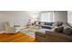 Inviting living room featuring a plush gray sectional sofa and decorative glass top coffee table at 735 Waterbrook Ter, Roswell, GA 30076