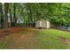 Backyard shed with a door, offering extra storage space and matching the property's aesthetic at 735 Waterbrook Ter, Roswell, GA 30076