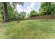 Expansive backyard featuring a fire pit, surrounded by lush greenery and a secure wooden fence at 2510 Brentwood Ct, Decatur, GA 30032