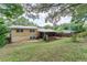 The backyard featuring a yellow home with a screened in back porch perfect for outdoor enjoyment at 2510 Brentwood Ct, Decatur, GA 30032