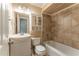 A bathroom with a white toilet, sink, vanity, mirror, medicine cabinet and a tiled tub and shower at 2510 Brentwood Ct, Decatur, GA 30032