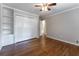 Bedroom featuring hardwood floors, a ceiling fan, and a built-in bookcase and closet at 2510 Brentwood Ct, Decatur, GA 30032