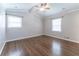 A bedroom with a ceiling fan, two windows, hardwood floors, and crown molding at 2510 Brentwood Ct, Decatur, GA 30032