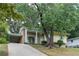 Attractive yellow home with brick accents, covered parking, and lush landscaping enhance the property's appeal at 2510 Brentwood Ct, Decatur, GA 30032