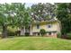 Inviting yellow home with brick accents, well-manicured lawn, and mature trees create a welcoming exterior at 2510 Brentwood Ct, Decatur, GA 30032