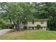 Charming yellow home with brick accents, well-manicured lawn, and mature trees offering shade and curb appeal at 2510 Brentwood Ct, Decatur, GA 30032