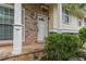 Close-up of the front door and porch featuring brick accents, stone details, and charming landscaping at 2510 Brentwood Ct, Decatur, GA 30032