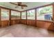 Enclosed porch with wood frame windows offers backyard views and ceiling fan at 2510 Brentwood Ct, Decatur, GA 30032