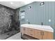 Bathroom featuring double vanity, marble-tiled shower, and modern lighting at 260 Sandy Lake Cir, Fayetteville, GA 30214