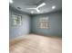 Bright bedroom with wood floors, a ceiling fan, and two windows at 260 Sandy Lake Cir, Fayetteville, GA 30214