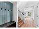 Light filled entryway featuring wainscoting, coat hooks, and hardwood stairs at 260 Sandy Lake Cir, Fayetteville, GA 30214