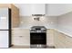 Stainless steel oven and cooktop with white range hood and light wood cabinets at 260 Sandy Lake Cir, Fayetteville, GA 30214
