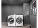 Laundry room with gray walls, tiled floor, and white washer and dryer at 260 Sandy Lake Cir, Fayetteville, GA 30214