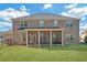 Large backyard with a brick home, screened porch, and well-maintained lawn perfect for outdoor activities at 4580 Cloister Cir, Hampton, GA 30228