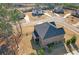 Aerial view of a beautiful brick home, surrounded by a well-kept lawn, mature trees and a quiet neighborhood setting at 4580 Cloister Cir, Hampton, GA 30228