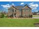 Charming two-story brick home with a manicured lawn and inviting front entrance at 4580 Cloister Cir, Hampton, GA 30228