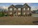 Handsome brick home with an inviting facade, manicured front yard, and a welcoming entryway at 4580 Cloister Cir, Hampton, GA 30228