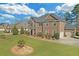 Stunning two-story brick home with a well-manicured lawn, attached garage, and mature landscaping at 4580 Cloister Cir, Hampton, GA 30228
