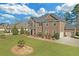 Beautifully landscaped yard surrounds this brick home with an attached two-car garage at 4580 Cloister Cir, Hampton, GA 30228
