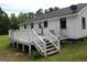 Back view of a home featuring a wooden deck at 124 Wynn Rd, Mcdonough, GA 30252