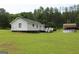 View of the home's backyard, featuring an above ground pool and a deck at 124 Wynn Rd, Mcdonough, GA 30252