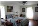 Bedroom with comfortable bed, wood floors, charming decor, and plenty of natural light at 124 Wynn Rd, Mcdonough, GA 30252